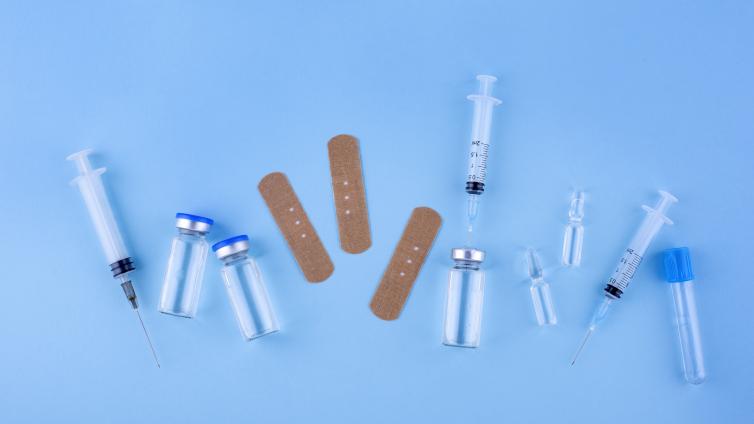 Top view of bandaids and vials in an arrangement 